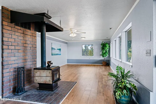 a living room with a flat screen tv and a refrigerator