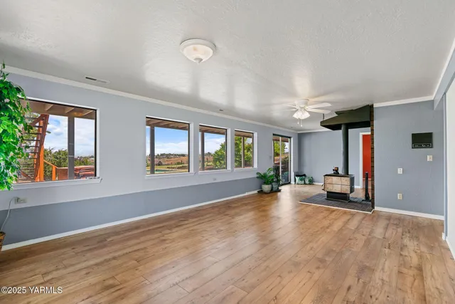 a view of a kitchen with a sink and dishwasher with wooden floor