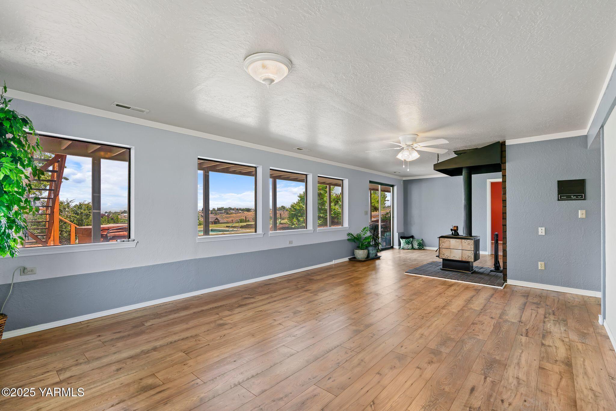 283 Cook Road Yakima, WA 98908 - Photo 35 of 64 a view of an empty room with wooden floor and a window