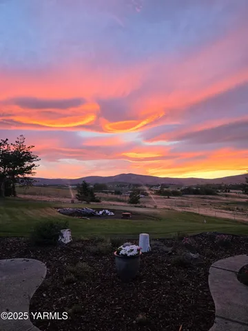 a view of a house with backyard and sitting area