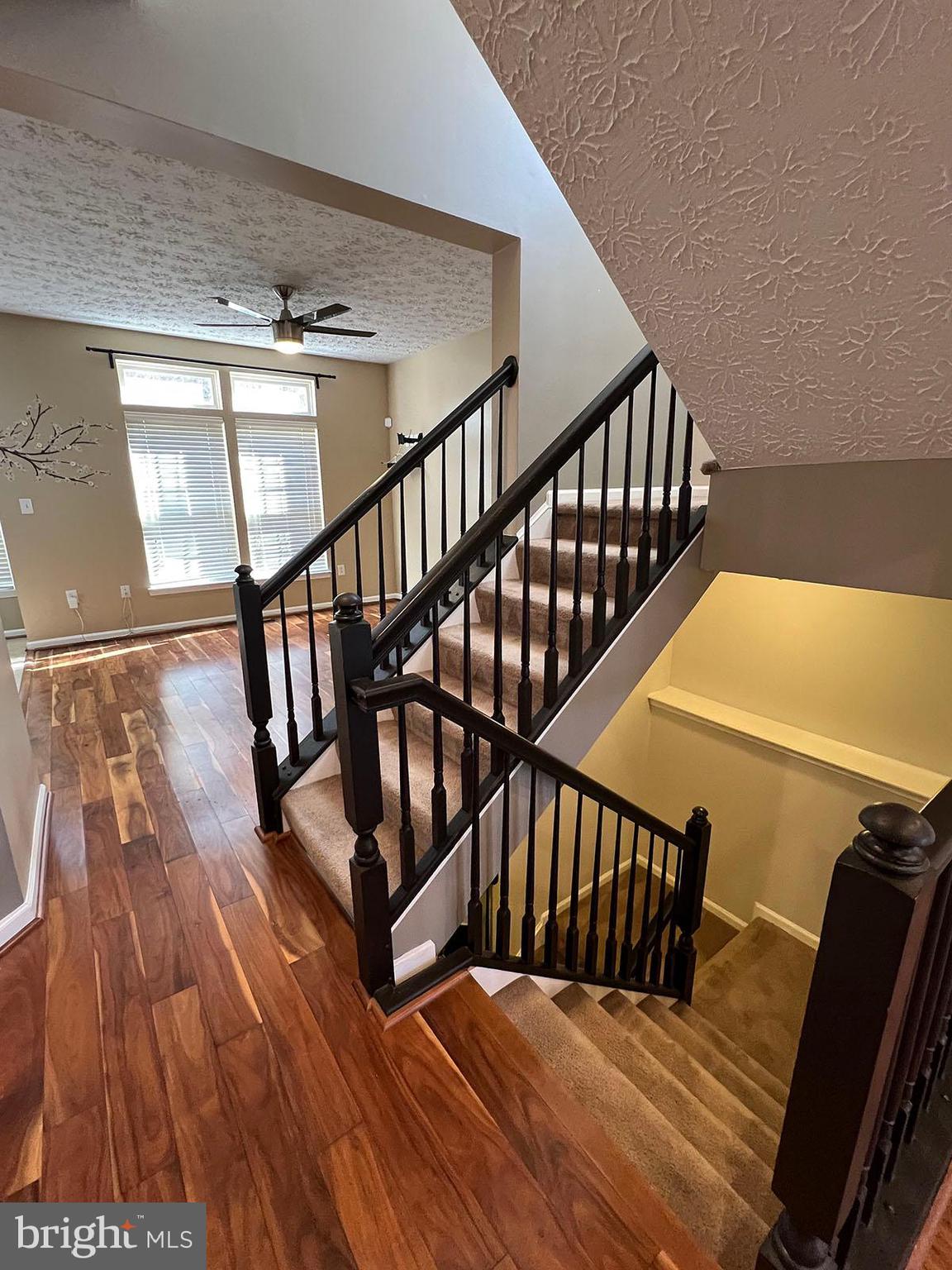 8334 Lyndhurst Street Laurel, MD 20724 - Photo 4 of 16 a view of staircase with wooden floor and a rug