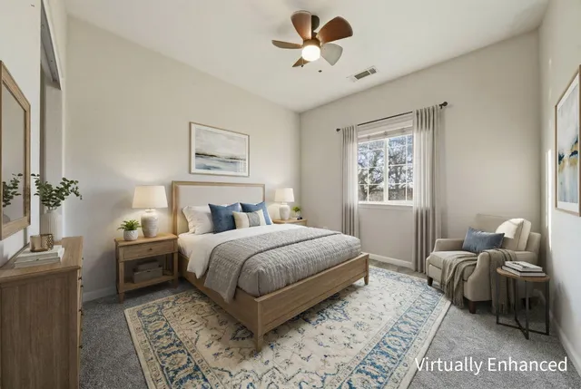 an empty room with a window and a ceiling fan