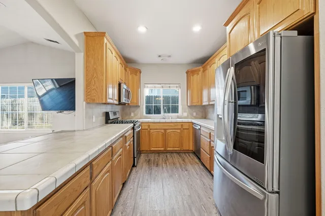 a kitchen with a refrigerator and a sink