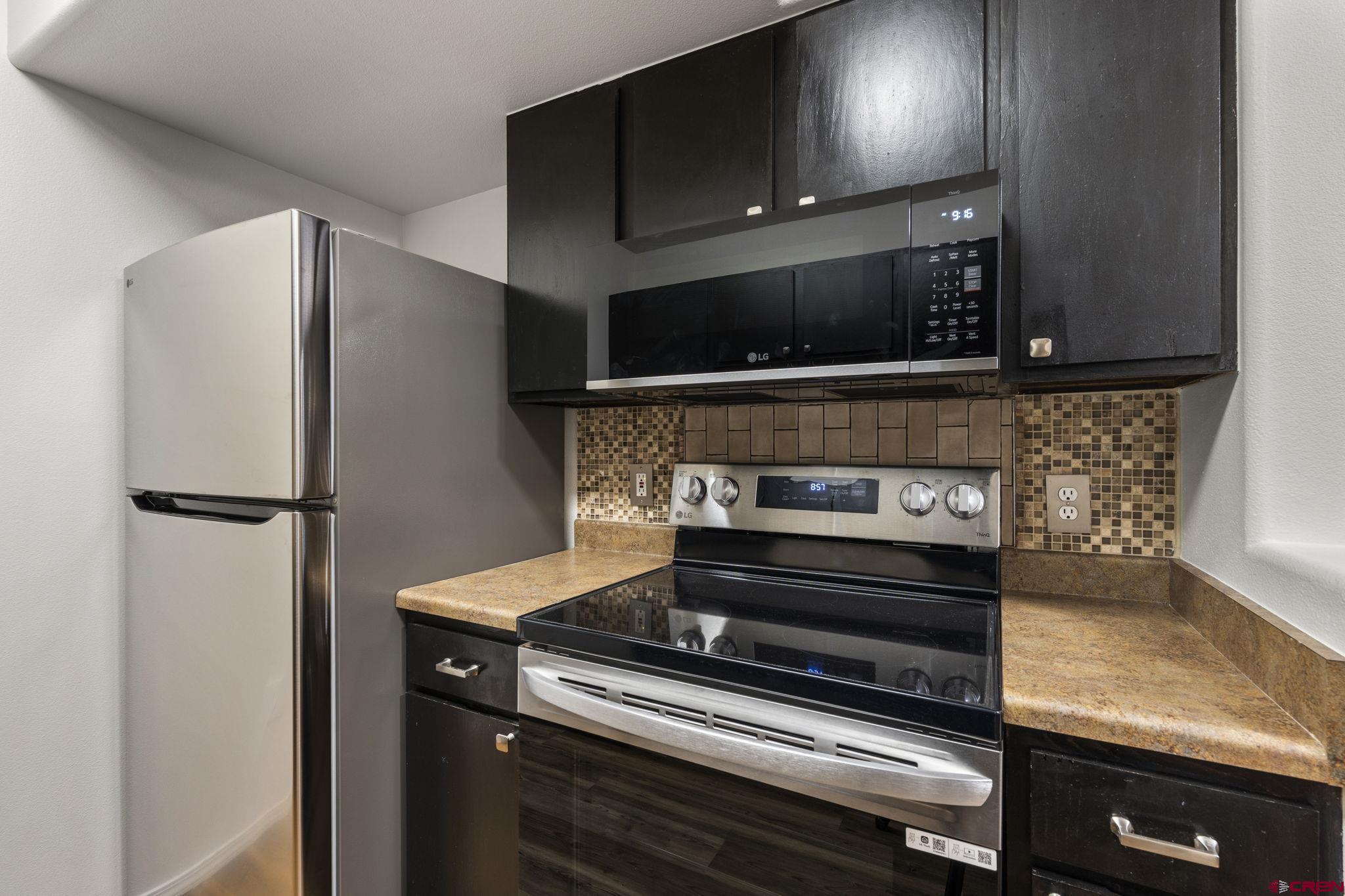 1100 Goeglein Gulch Road, Unit 171 Durango, CO 81301 - Photo 11 of 40 a stove top oven sitting inside of a kitchen