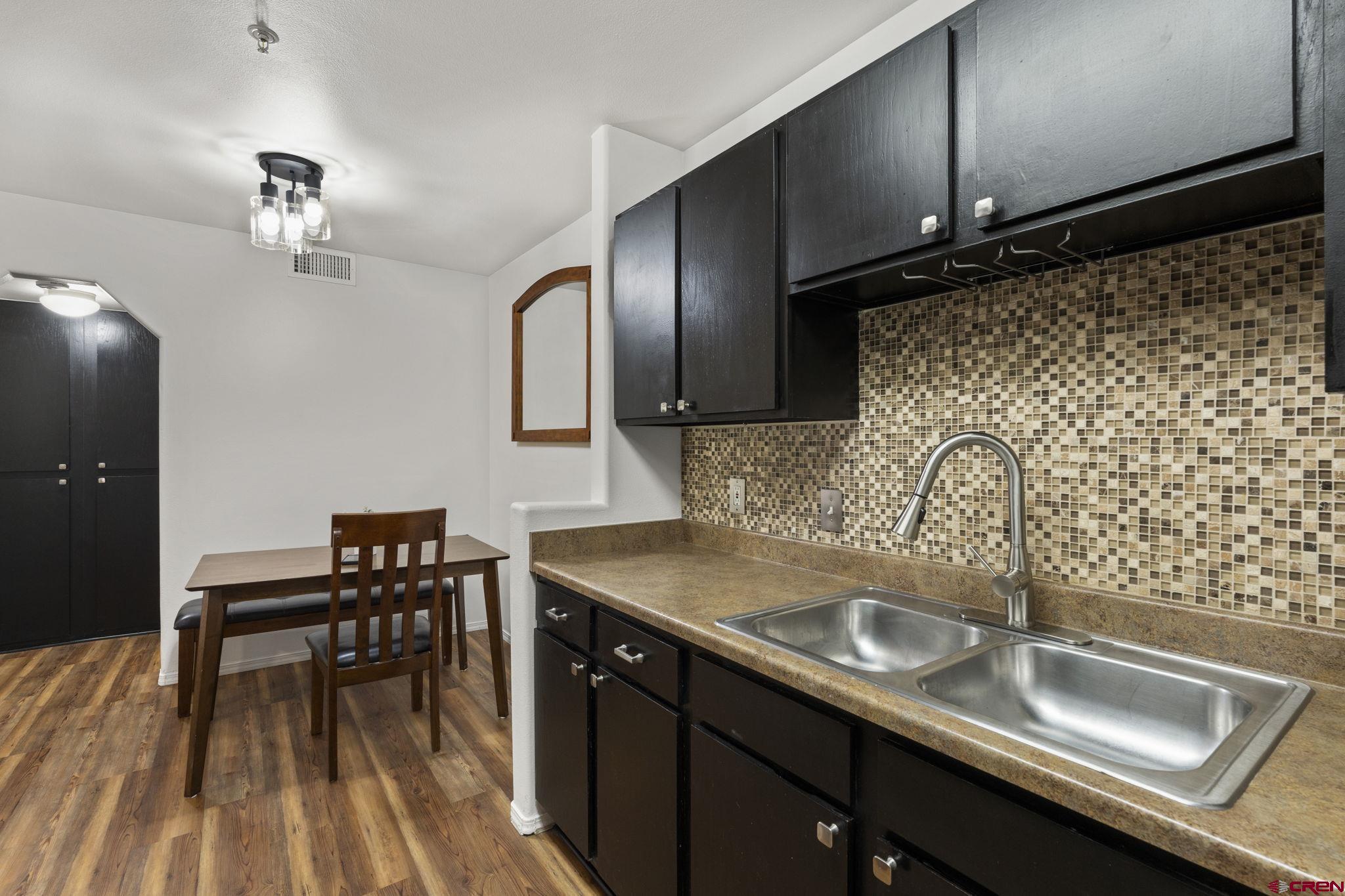 1100 Goeglein Gulch Road, Unit 171 Durango, CO 81301 - Photo 13 of 40 a kitchen with a sink cabinets and wooden floor