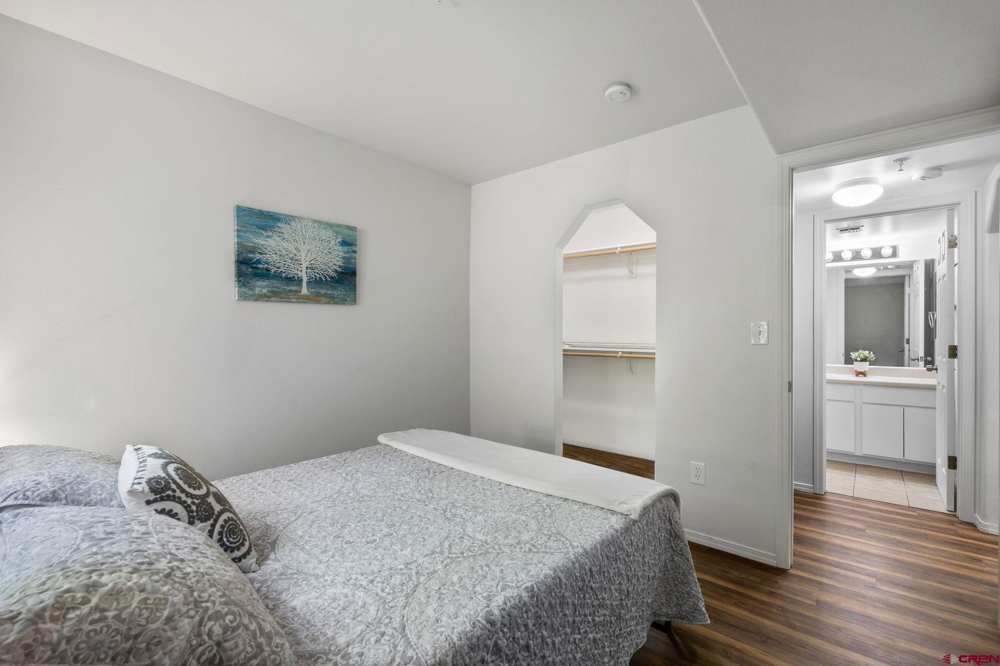 1100 Goeglein Gulch Road, Unit 171 Durango, CO 81301 - Photo 16 of 40 a bedroom with a bed and a painting on the wall
