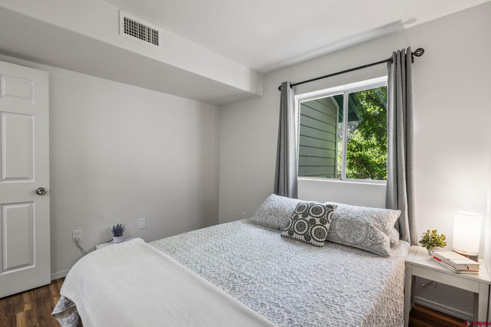 1100 Goeglein Gulch Road, Unit 171 Durango, CO 81301 - Photo 17 of 40 a bedroom with a large bed and a window