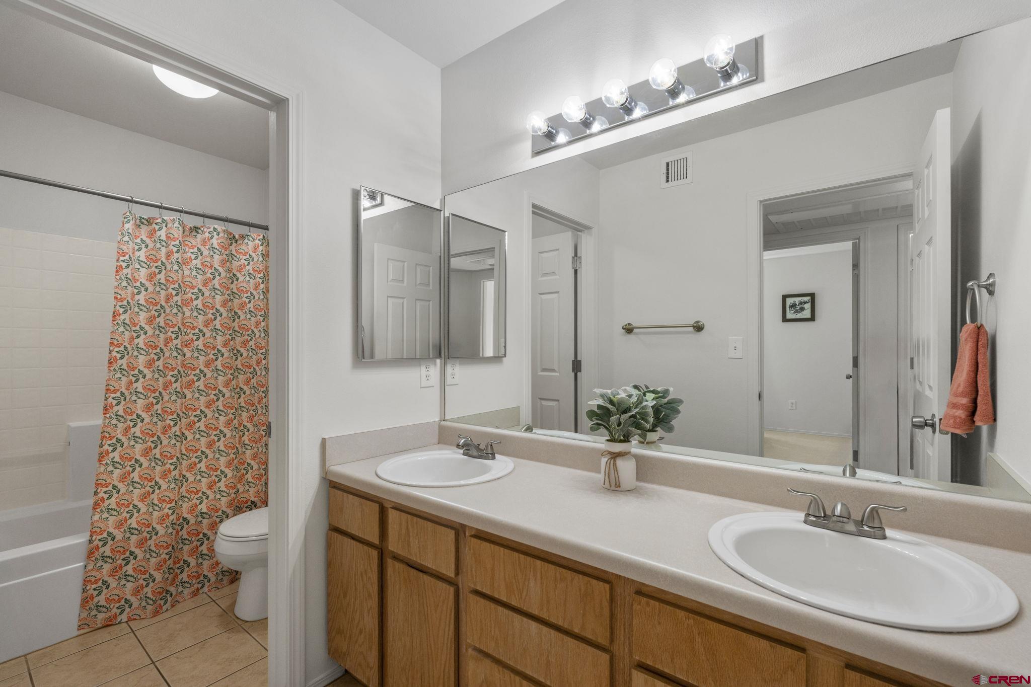 1100 Goeglein Gulch Road, Unit 171 Durango, CO 81301 - Photo 24 of 40 a bathroom with a sink double vanity and a mirror