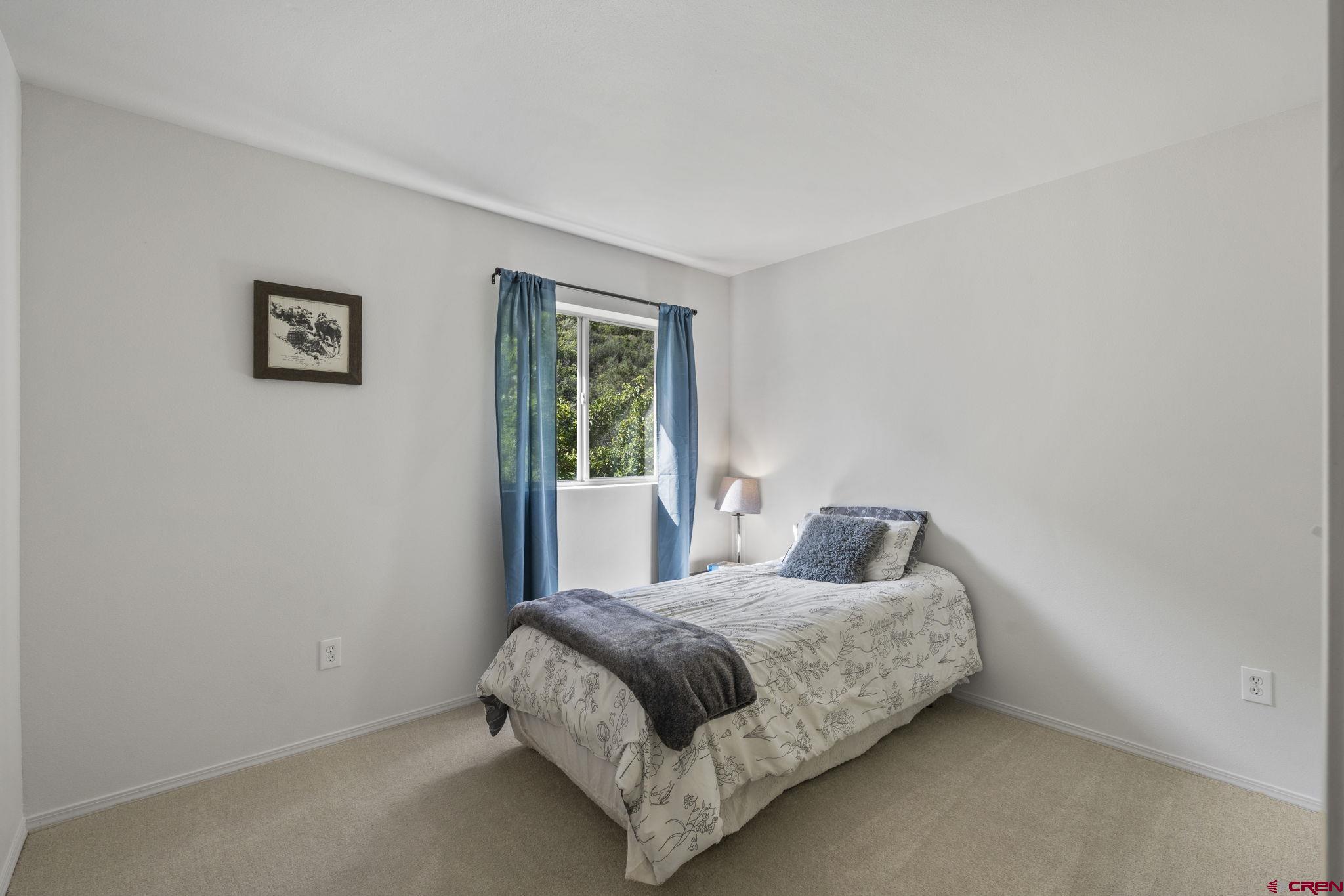 1100 Goeglein Gulch Road, Unit 171 Durango, CO 81301 - Photo 26 of 40 a bedroom with a bed and a window