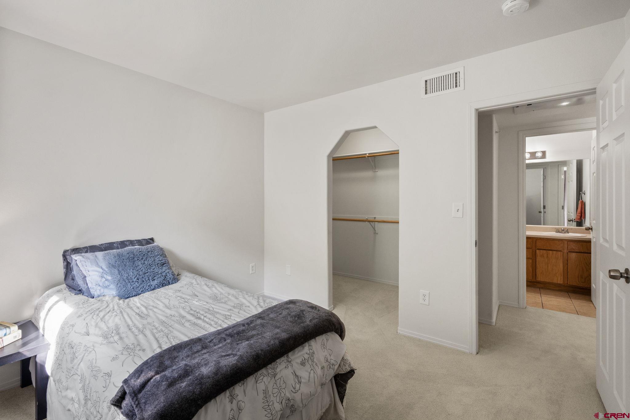 1100 Goeglein Gulch Road, Unit 171 Durango, CO 81301 - Photo 27 of 40 a bedroom with a bed and a view of bathroom
