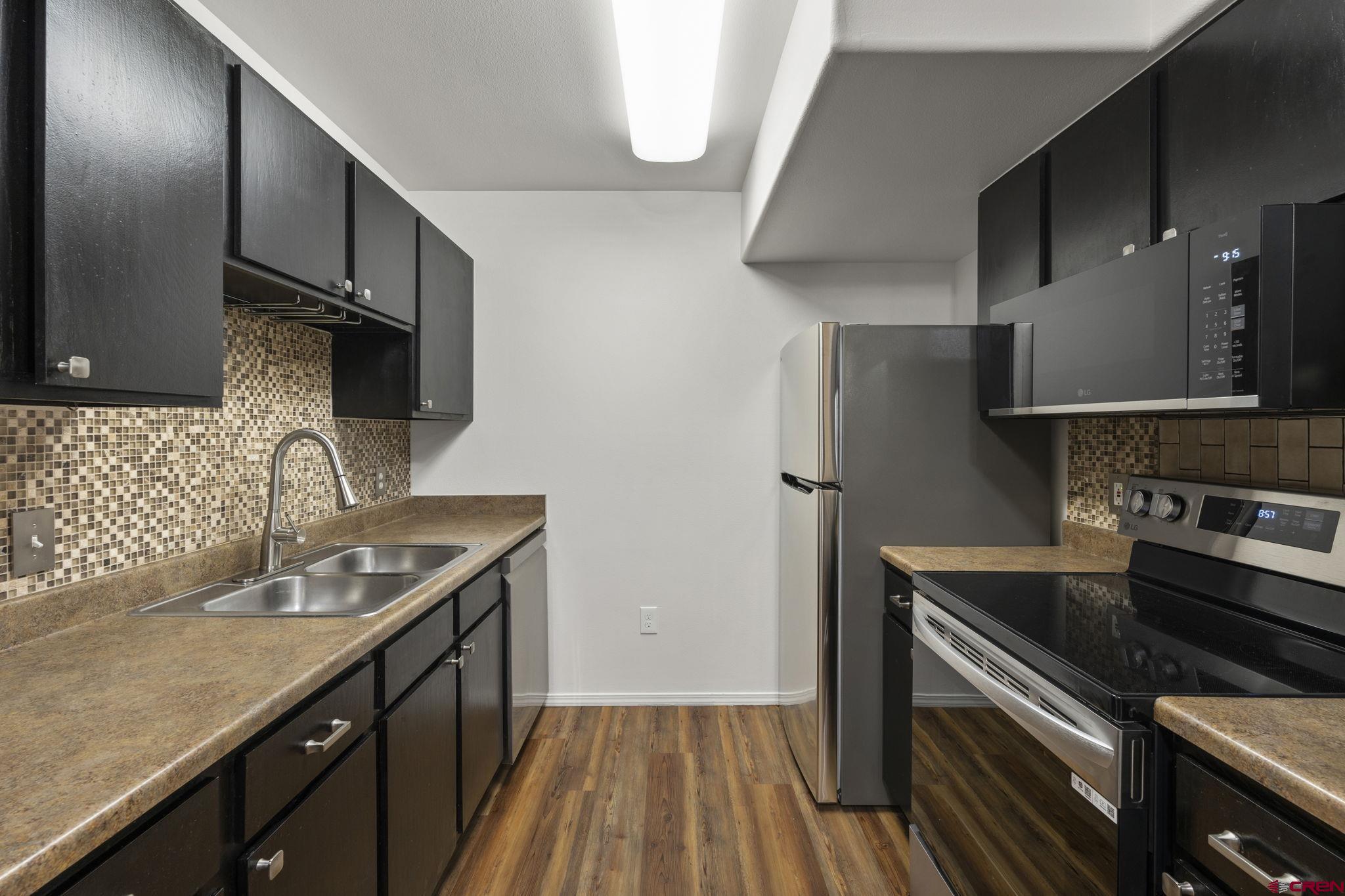 1100 Goeglein Gulch Road, Unit 171 Durango, CO 81301 - Photo 10 of 40 a kitchen with granite countertop a sink stainless steel appliances and cabinets