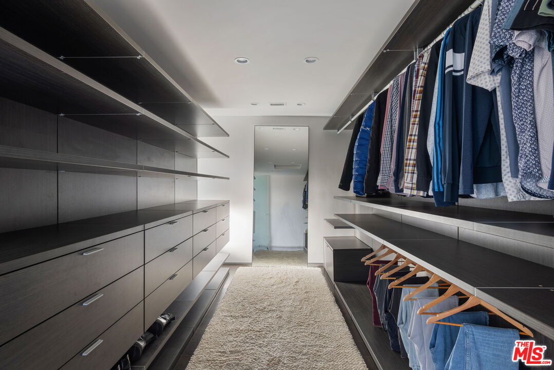 3337 Beverly Ranch Road Beverly Hills, CA 90210 - Photo 25 of 36 a view of walk in closet with clothes and shoes