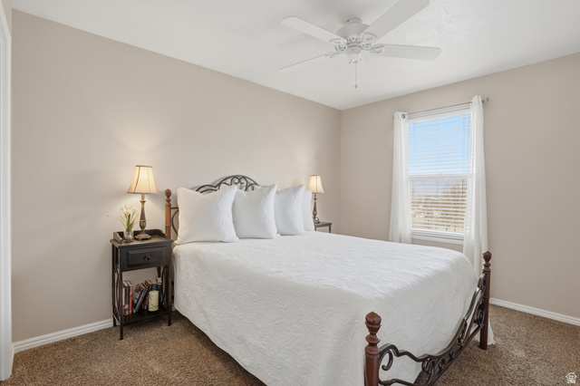 7737 Ranches Parkway Eagle Mountain, UT 84005 - Photo 13 of 28 Bedroom featuring neutral wall tones and textured carpeting