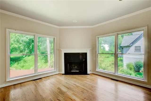 a view of a hallway with windows and chandelier