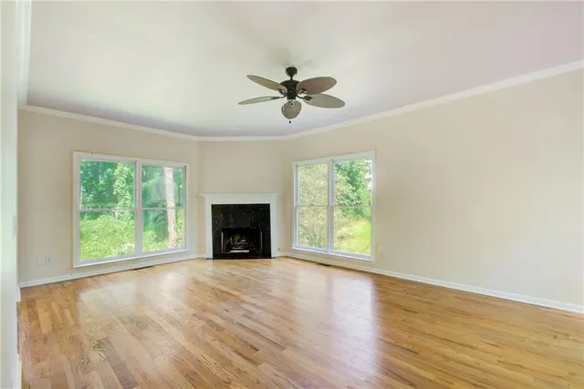 wooden floor in an empty room with a window