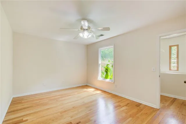a view of a house with backyard and a tree