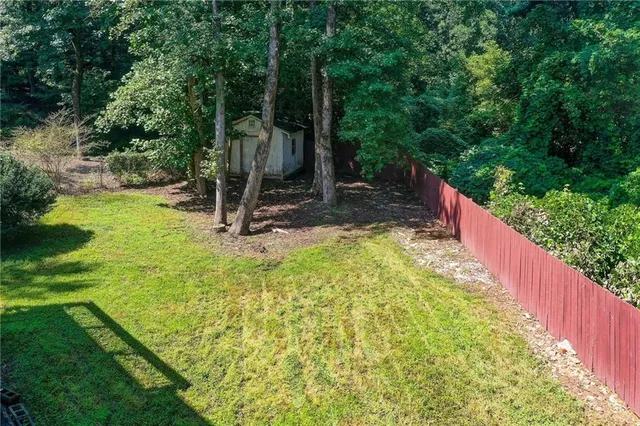 an aerial view of a house with a yard basket ball court and outdoor seating