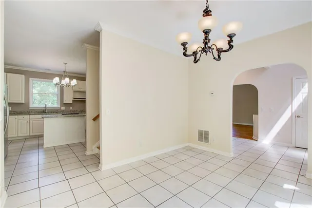 a kitchen with a sink a refrigerator and cabinets