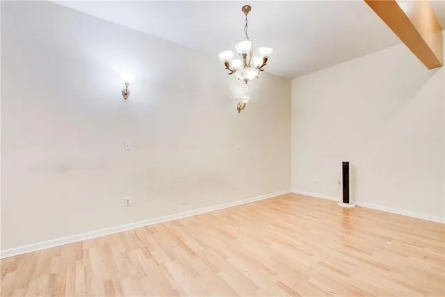 a bathroom with a granite countertop sink a light fixture and a mirror