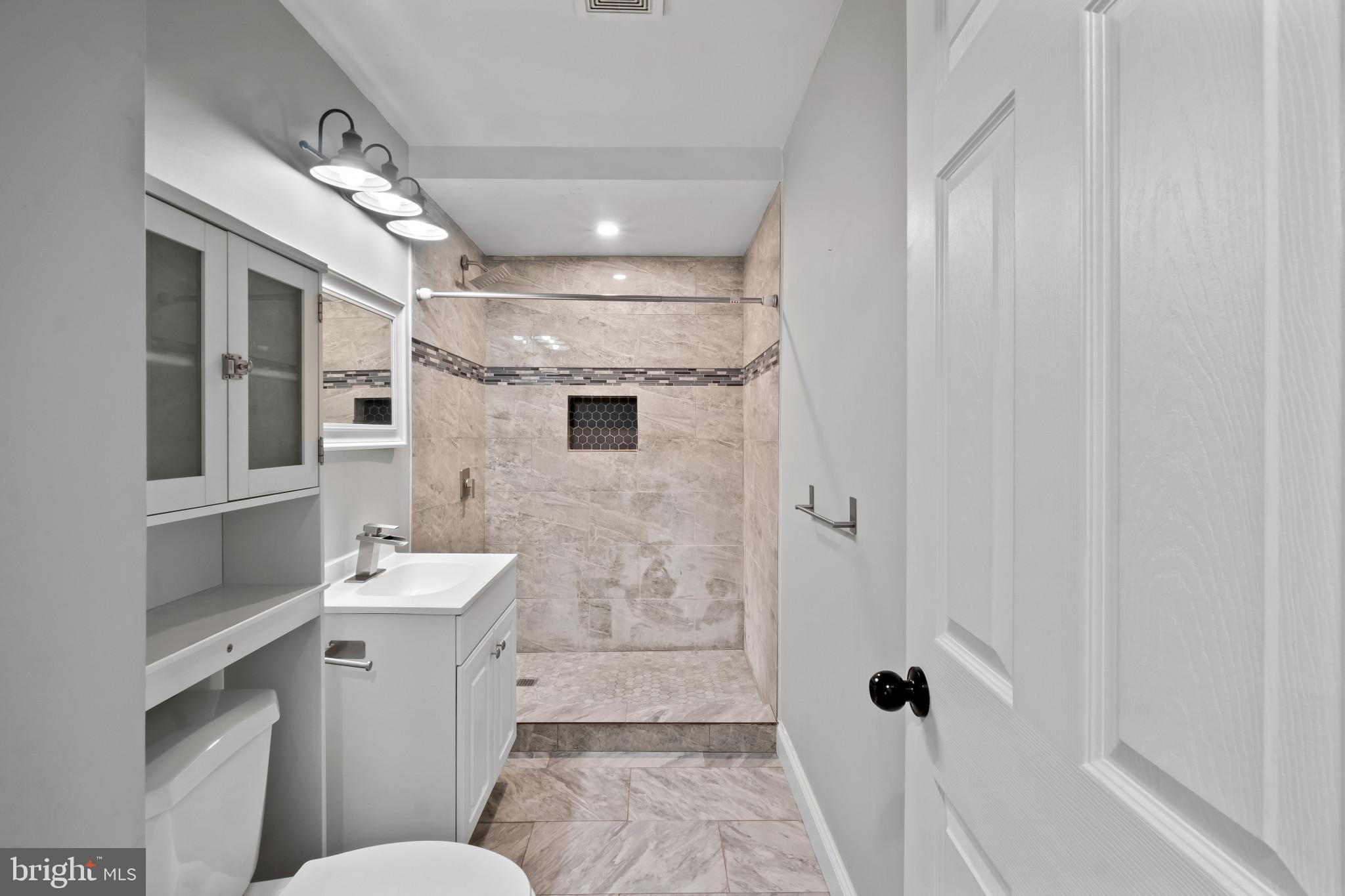 3412 Sollers Point Road Dundalk, MD 21222 - Photo 11 of 31 a bathroom with a toilet sink and shower