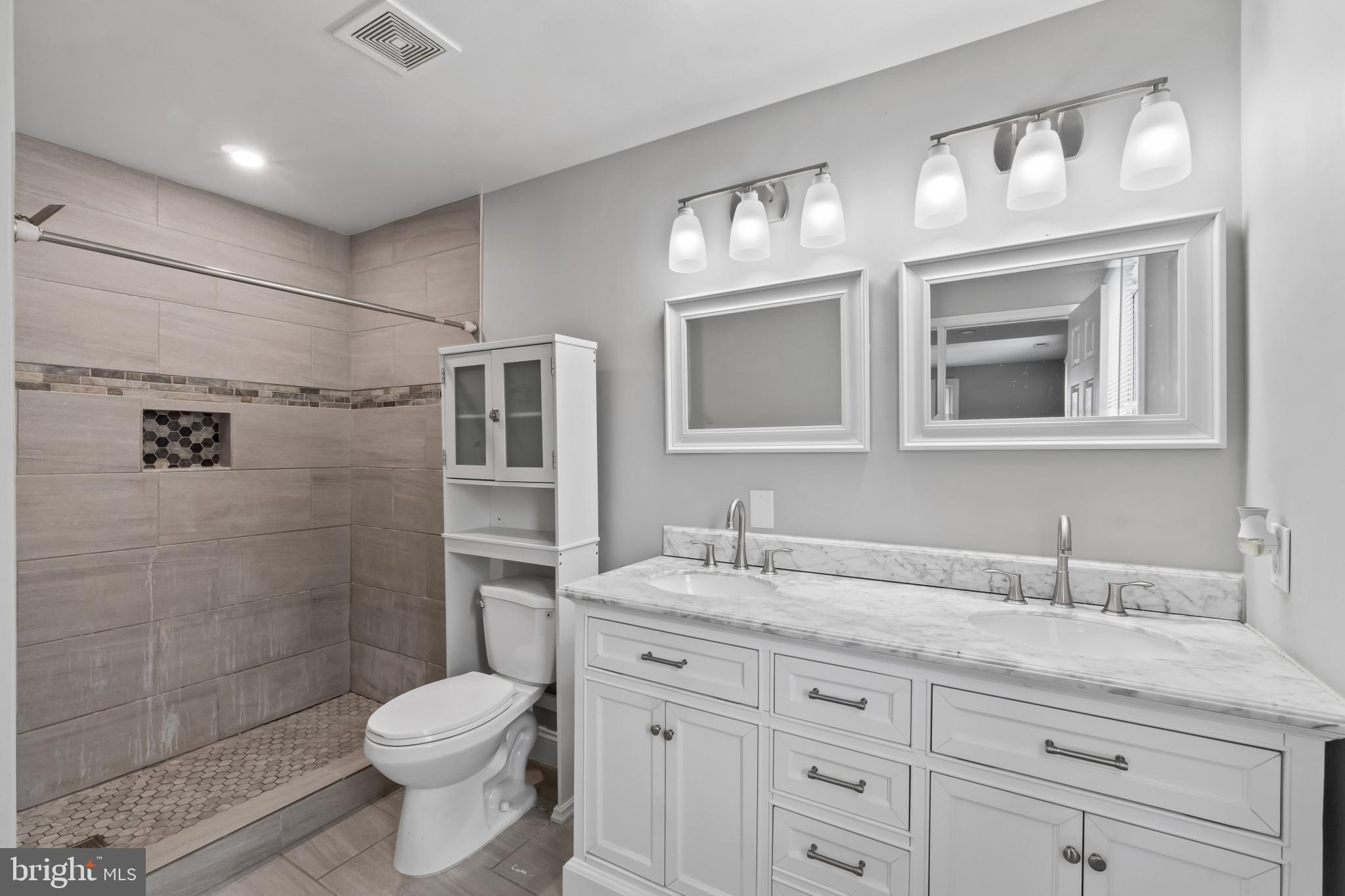 3412 Sollers Point Road Dundalk, MD 21222 - Photo 12 of 31 a bathroom with a granite countertop toilet sink shower and mirror
