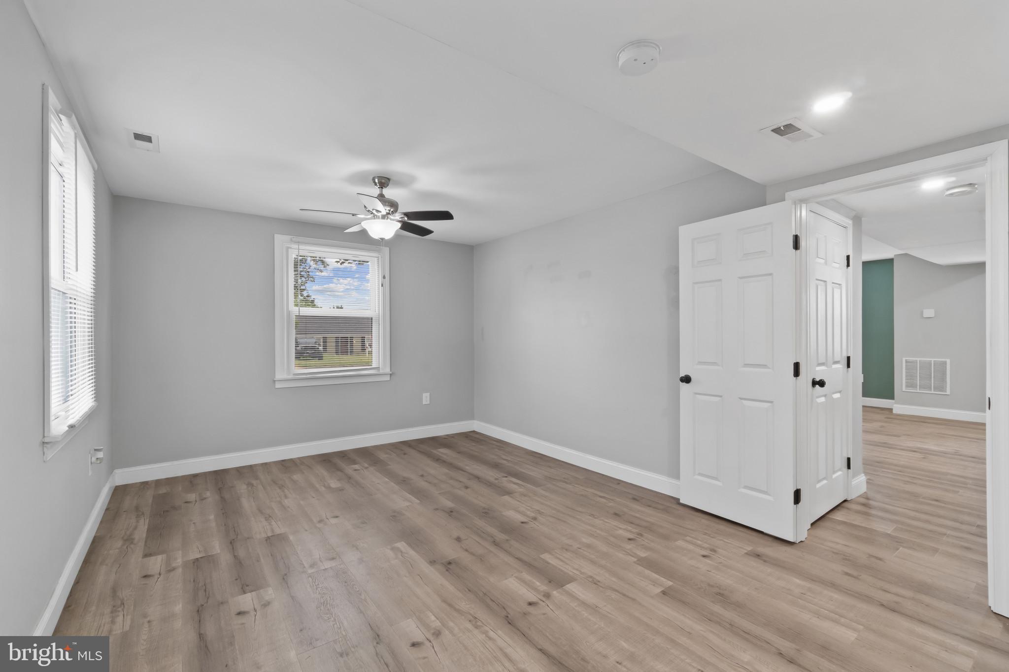 3412 Sollers Point Road Dundalk, MD 21222 - Photo 13 of 31 wooden floor in an empty room with a window