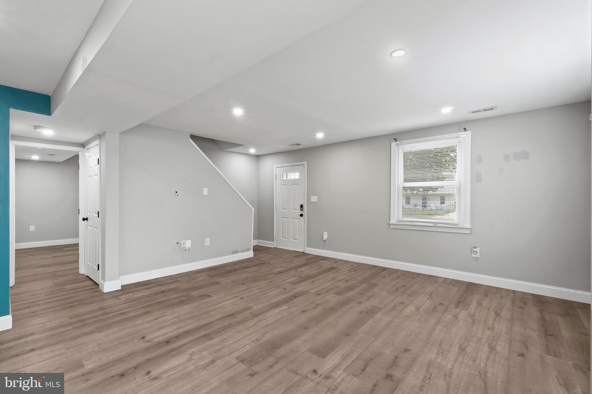 3412 Sollers Point Road Dundalk, MD 21222 - Photo 19 of 31 an empty room with wooden floor and windows