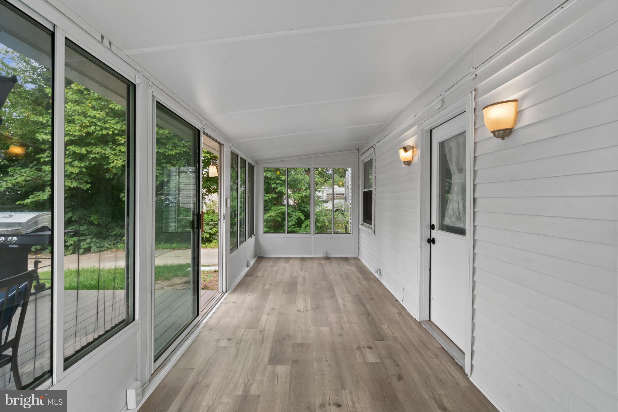 3412 Sollers Point Road Dundalk, MD 21222 - Photo 26 of 31 a view of hallway with a large window and wooden floor
