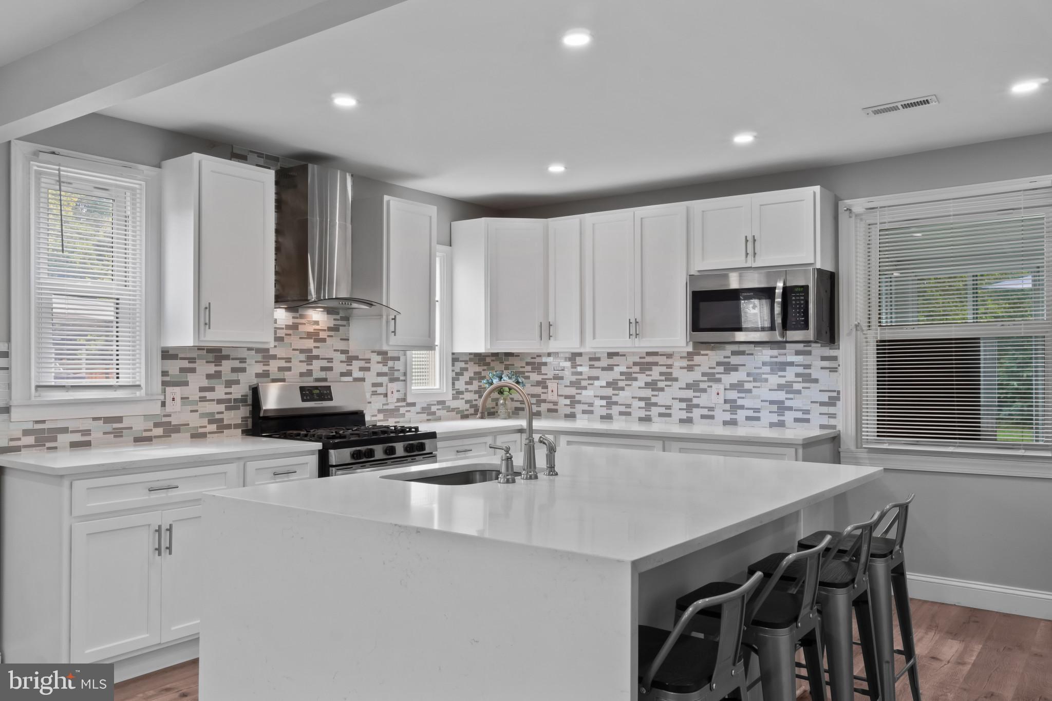 3412 Sollers Point Road Dundalk, MD 21222 - Photo 5 of 31 a kitchen with stainless steel appliances kitchen island granite countertop a sink and cabinets