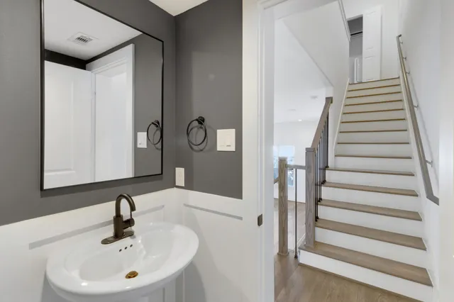 a bathroom with a sink vanity and toilet