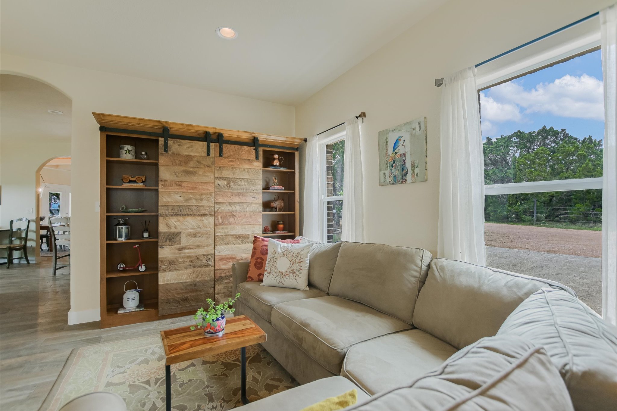 590 Rancho Grande Drive Wimberley, TX 78676 - Photo 16 of 30 a living room with furniture and a floor to ceiling window