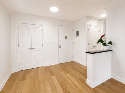 a bedroom with a bed and a couch next to a window