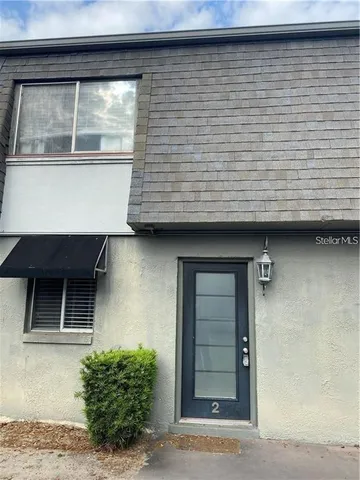 a view of a swimming pool with a patio and a yard