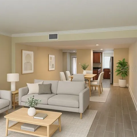 a view of an empty room with wooden floor and a door
