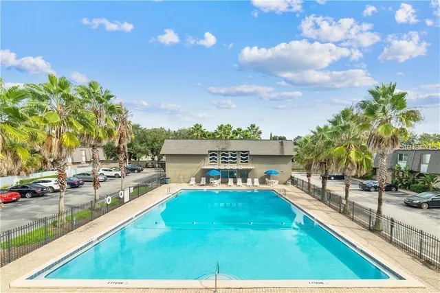 a kitchen with stainless steel appliances granite countertop a refrigerator a stove and a sink with wooden floor