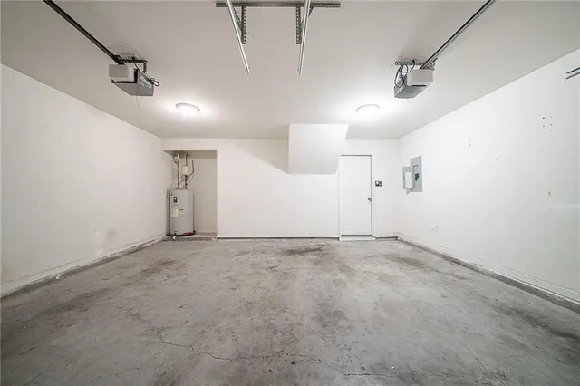 an empty room with an entryway and windows