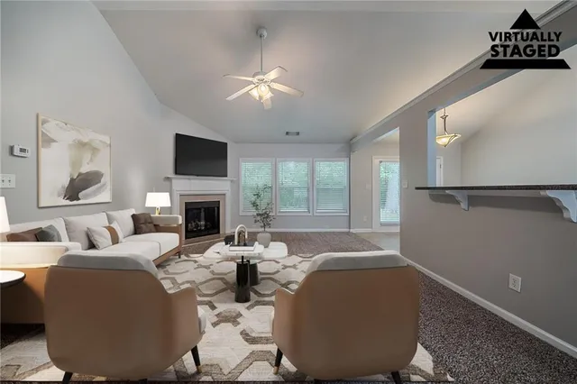 a living room with furniture a fireplace and a flat screen tv