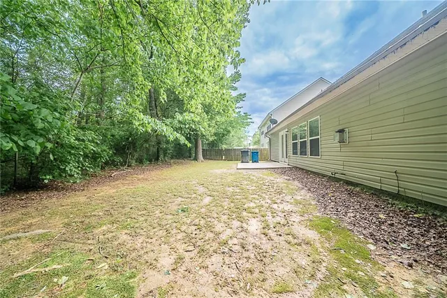 a backyard of a house with lots of green space