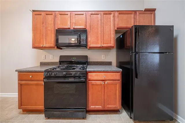 a kitchen with stainless steel appliances granite countertop a refrigerator stove and microwave