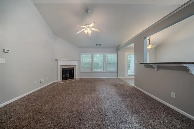 a view of empty room with window and fireplace