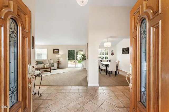 a living room with furniture and a dining table with kitchen view
