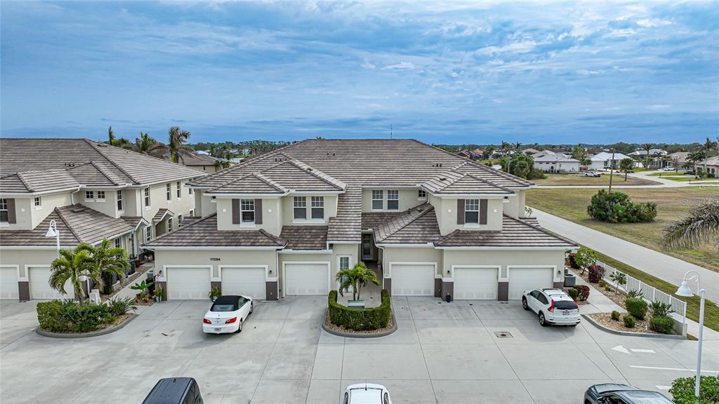 an aerial view of a house with swimming pool and furniture