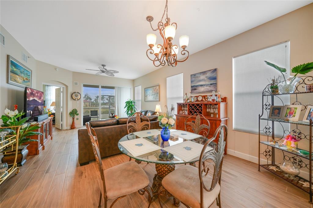 17094 Acapulco Road, Unit 313 Punta Gorda, FL 33955 - Photo 11 of 49 a view of a dining room with furniture and wooden floor