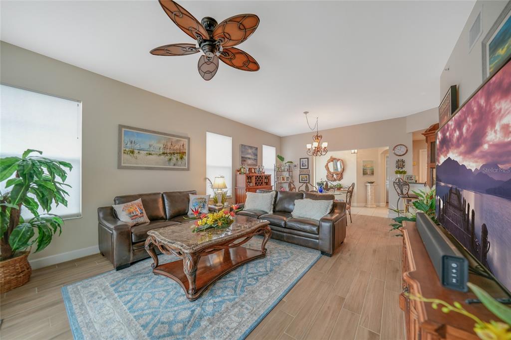 17094 Acapulco Road, Unit 313 Punta Gorda, FL 33955 - Photo 13 of 49 a living room with furniture and a flat screen tv