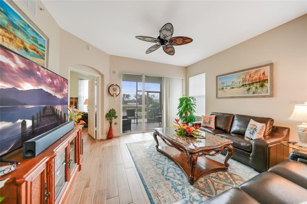17094 Acapulco Road, Unit 313 Punta Gorda, FL 33955 - Photo 14 of 49 a living room with furniture and a flat screen tv