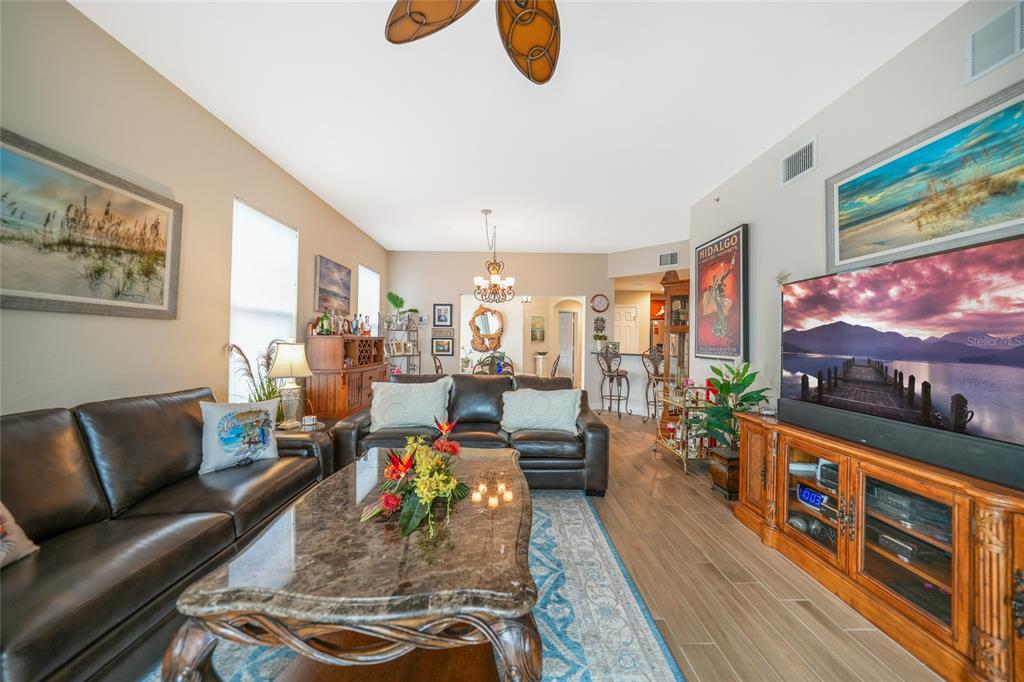17094 Acapulco Road, Unit 313 Punta Gorda, FL 33955 - Photo 15 of 49 a living room with furniture and a flat screen tv