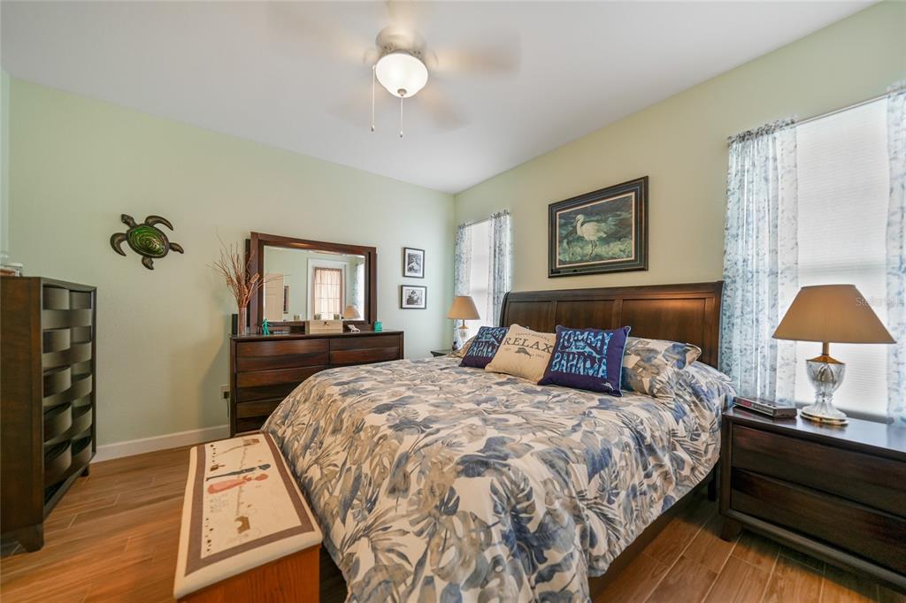 17094 Acapulco Road, Unit 313 Punta Gorda, FL 33955 - Photo 18 of 49 a bedroom with a bed and a lamp on dresser