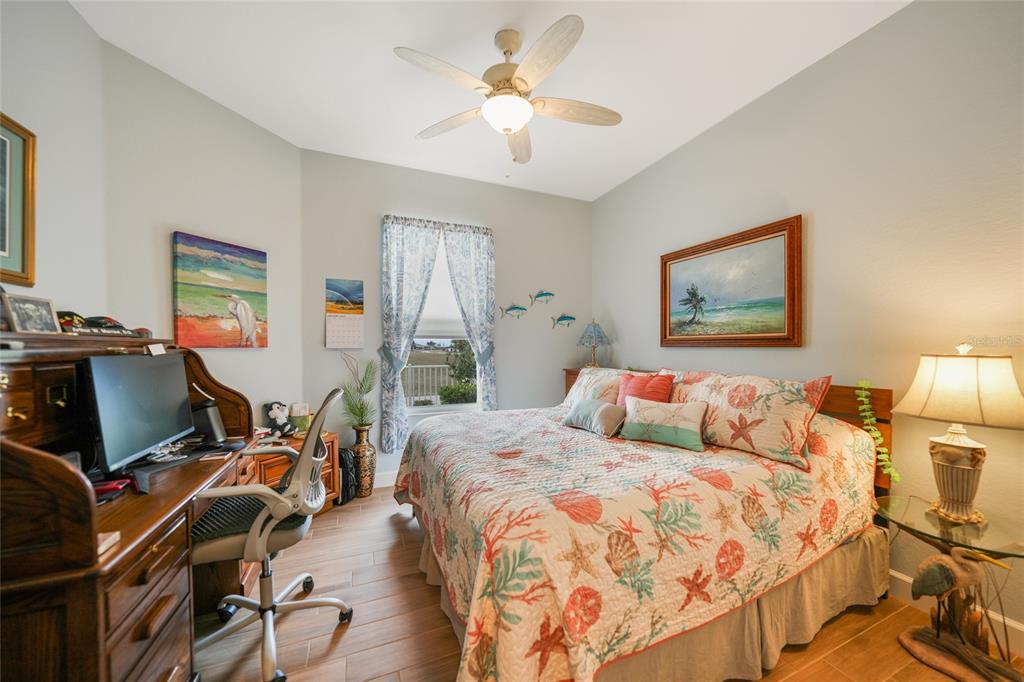 17094 Acapulco Road, Unit 313 Punta Gorda, FL 33955 - Photo 24 of 49 a bedroom with two beds and a desk