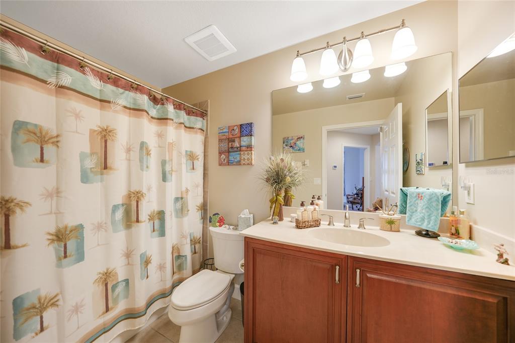17094 Acapulco Road, Unit 313 Punta Gorda, FL 33955 - Photo 25 of 49 a bathroom with a sink a toilet a mirror a vanity and shower