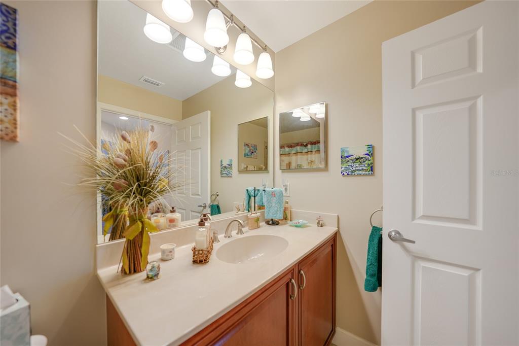 17094 Acapulco Road, Unit 313 Punta Gorda, FL 33955 - Photo 26 of 49 a bathroom with a sink a mirror and a vanity